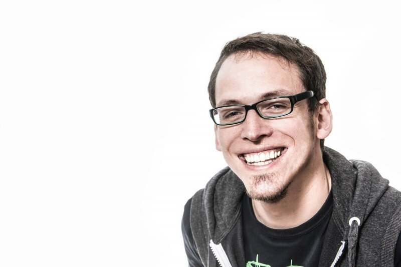 portrait-of-young-laughing-man-on-white-background